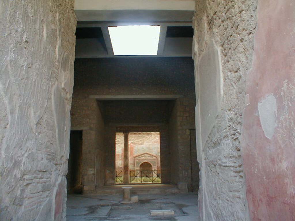 VI.8.23 Pompeii. September 2004. Looking west from entrance corridor, across impluvium in atrium towards tablinum.