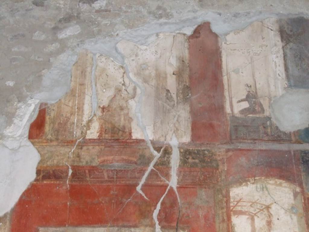 VI.9.6 Pompeii. March 2009. Room 8, painted decoration from upper centre of west wall.
Kuivalainen describes the central figure as -
“An enthroned frontal figure holding a cantharus in his right hand and a thyrsus in his left; the hips and legs are covered with a himation.”
He comments that –
“The identification of this partly robed and effeminate figure as Bacchus with his characteristic attributes is more likely than Libera or Ariadne, who are seldom depicted in this pose.”
See Kuivalainen, I., 2021. The Portrayal of Pompeian Bacchus. Commentationes Humanarum Litterarum 140. Helsinki: Finnish Society of Sciences and Letters, (p.100, B10).