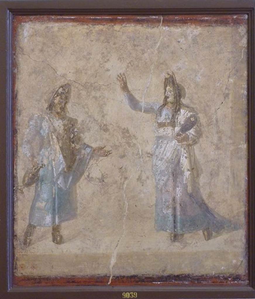 VI.9.6 Pompeii. Found on 1st July 1828 in room176, the west wall of the pseudo- peristyle.
Wall painting of masked actors possibly performing the myth of Auge because of the swaddled baby (Telephus?) in the arms of the woman. Now in Naples Archaeological Museum. Inventory number 9039. See Helbig, W., 1868. Wandgemälde der vom Vesuv verschütteten Städte Campaniens. Leipzig: Breitkopf und Härtel. (1465).