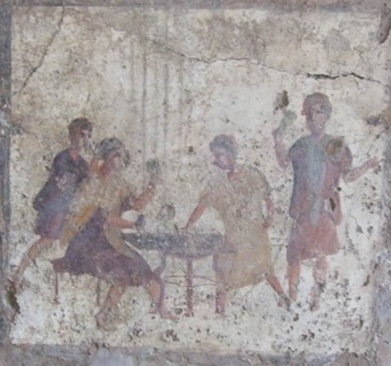 VI.10.1 Pompeii.  March 2009.  Rear room on north side.  Fresco on west wall.  Two men in tunics and wearing shoes sit at a table.  A man in a blue tunic sits on a bench and a man in a brown tunic leans over him.  See Helbig, W., 1868. Wandgemälde der vom Vesuv verschütteten Städte Campaniens. Leipzig: Breitkopf und Härtel. (1504; p369).