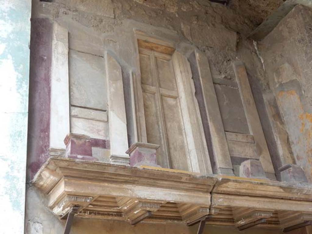 VI.12.2 Pompeii. May 2015. Entrance fauces, detail of upper east wall with shelf and façade with small columns.
Photo courtesy of Buzz Ferebee.