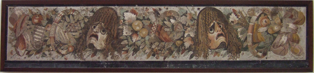 VI.12.2 Pompeii. Mosaic of two tragic masks between a group of flowers, fruits and garlands.
Found in VI.12.2 as a threshold dividing the fauces (room 53) from the atrium, on 28th October 1830.
See Mau, A., 1907, translated by Kelsey F. W. Pompeii: Its Life and Art. New York: Macmillan. (p. 290).
Now in Naples Archaeological Museum. Inventory number 9994.
According to Fiorelli, the tablinum 33 was also separated from the atrium, by a mosaic threshold of masks and garlands.
He described this as reputed to be one of the most stupendous works of art, due to the excellence of the design, colours and workmanship.
See Pappalardo, U., 2001. La Descrizione di Pompei per Giuseppe Fiorelli (1875). Napoli: Massa Editore, (p.71)
See PAH II, 240.