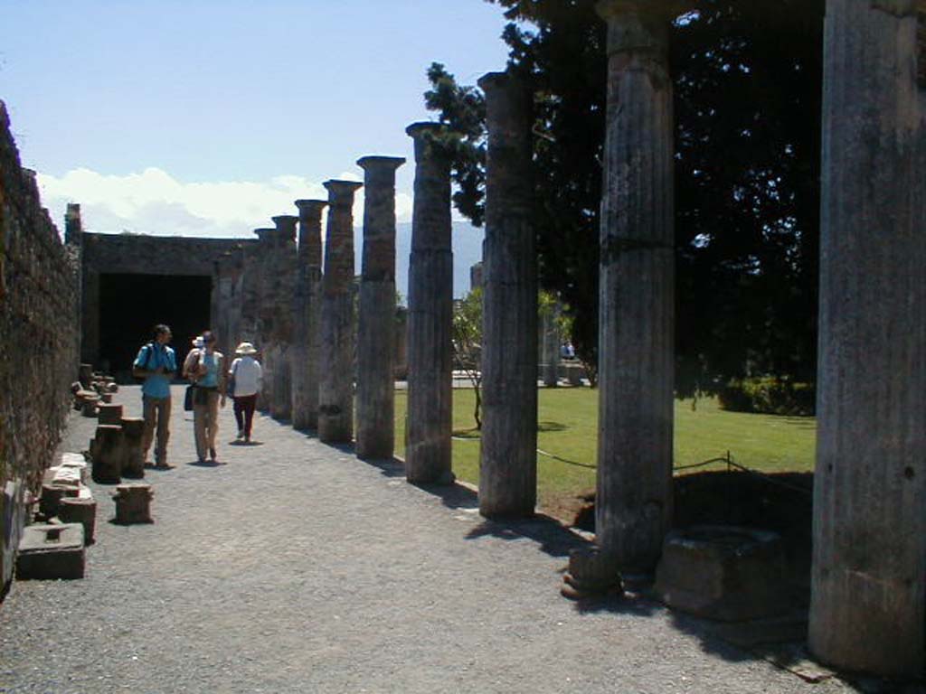 VI.12.2 Pompeii. May 2004. Looking south along east portico of rear peristyle.
According to Jashemski, the rear peristyle was enclosed by 43 stuccoed columns.
Below the two middle columns of the south portico there was a marble puteal, and beside it a marble table supported by a winged sphinx with the feet of a dog. Fragments of two statuettes were found in the garden.
See Jashemski, W. F., 1993. The Gardens of Pompeii, Volume II: Appendices. New York: Caratzas. (p.145)