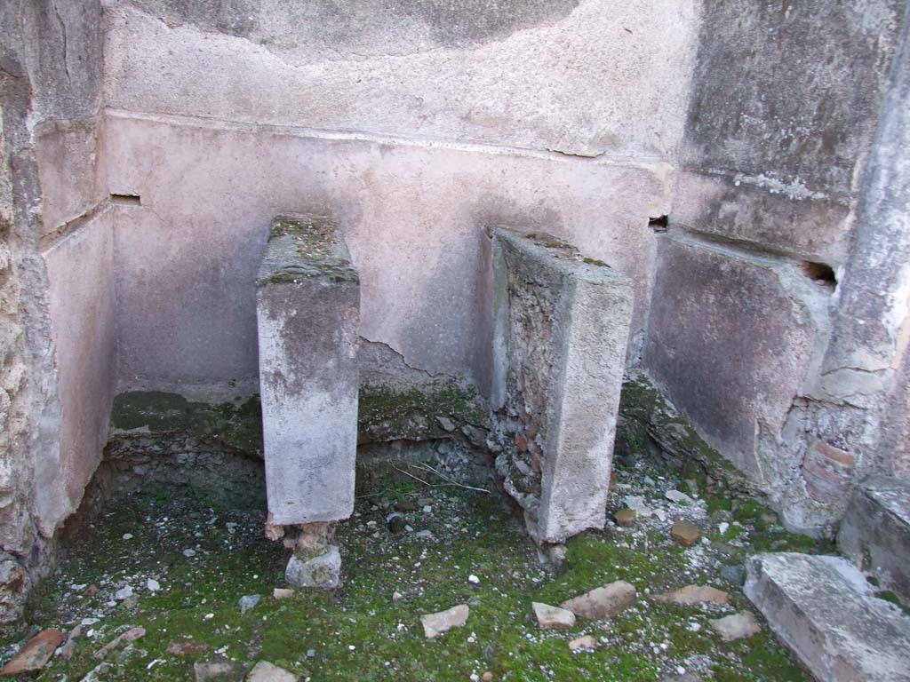 VI.14.22 Pompeii. December 2007. Room 12, three basins.
According to Seyffert, clothes when sent to be cleaned were stamped with the feet in pits or troughs filled with warm water and substances which separated the fat from them, as urine, nitre, and fuller's earth. If the object was to felt the web, and make it thicker and stronger, the same process was gone through, and the cloth was then beaten with rods, washed out in clean water, dried, carded with a kind of thistle or with the skin of a hedgehog, fumigated with sulphur, rubbed in with fuller's earth to make it whiter and stronger, and finally dressed by brushing, shearing, and pressing. The fuller's earth, when well rubbed in, pre¬vented the clothes from getting dirty too soon, and freshened up the colours which the sulphur had destroyed.
See Seyffert, Dr O., 1894, Dictionary of Classical Antiquities, London: William Glaisher. (p.243-4).