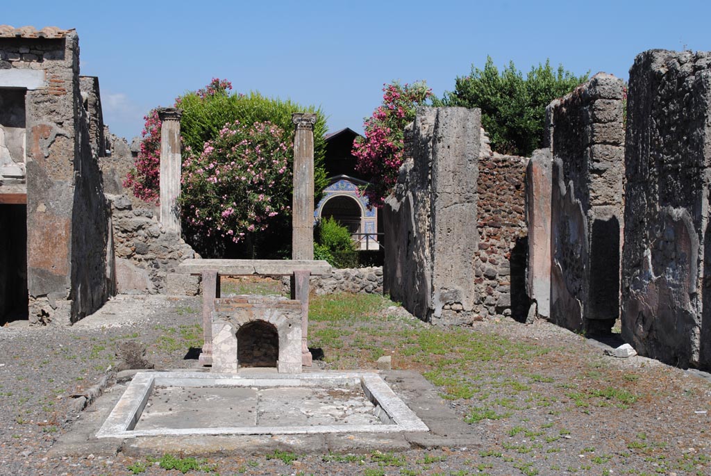 VI.14.43 Pompeii. July 2012. Room 1, looking east across impluvium in atrium, towards tablinum, and garden area.
Photo courtesy of John Vanko. His father took the identical photo in February 1952, see below.