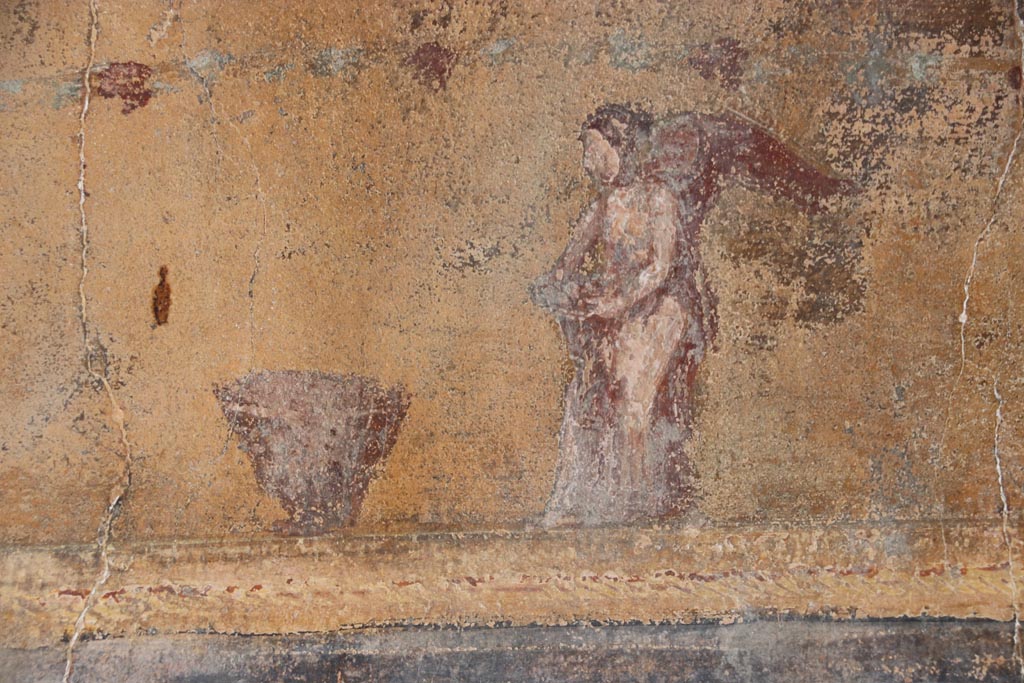VI.15.1 Pompeii. October 2023.
North wall of atrium, detail from lower east end of yellow panel above site of strongbox. Photo courtesy of Klaus Heese.