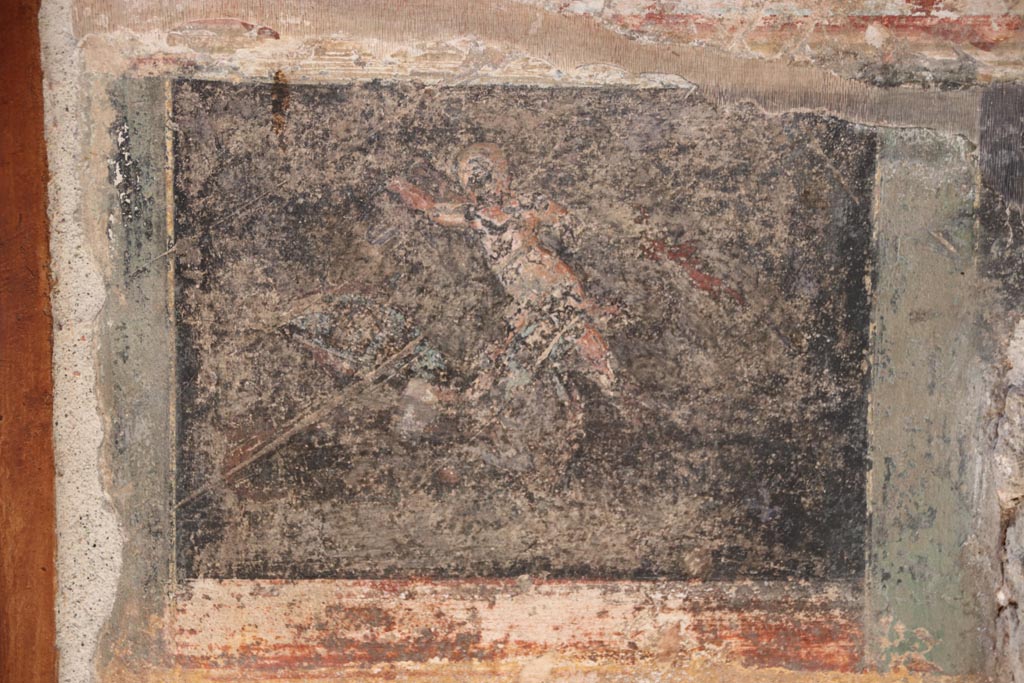 VI.15.1 Pompeii. October 2023.
Detail from north wall of atrium, painted decoration from west side of masonry base for strongbox.
Photo courtesy of Klaus Heese.