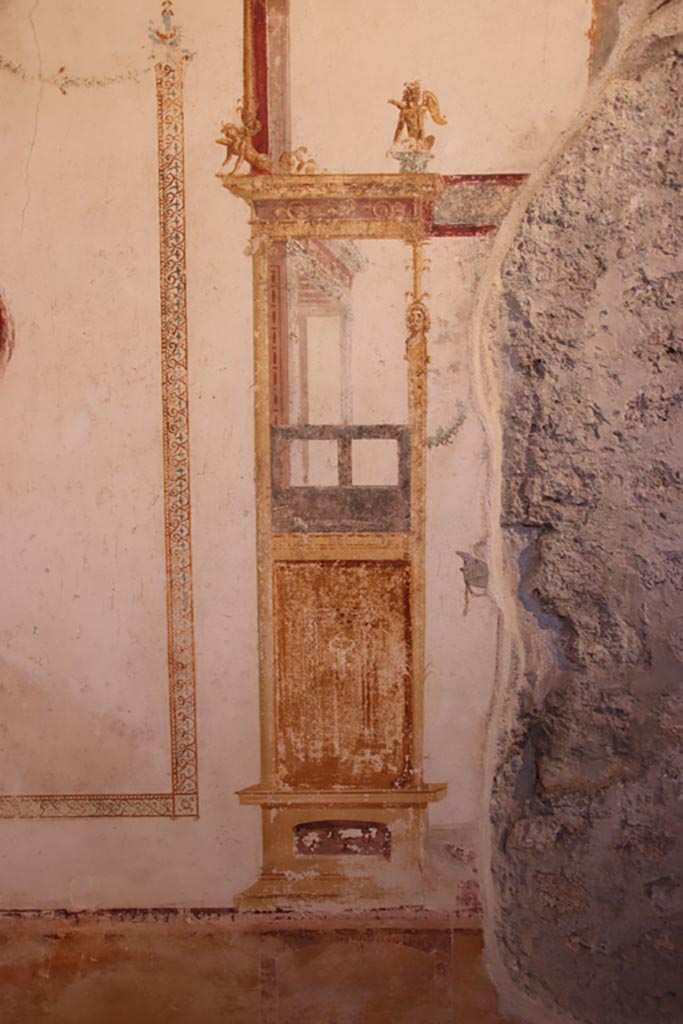 VI.15.1 Pompeii. October 2023.
Detail of painted decoration from panel on west wall of oecus, on south end of central panel.
Photo courtesy of Klaus Heese.