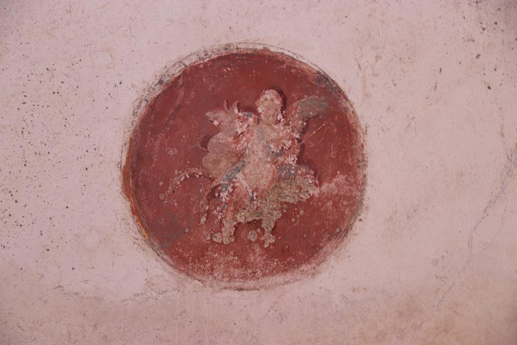 VI.15.1 Pompeii. October 2023. Detail from decorative medallion from north end of west wall. Photo courtesy of Klaus Heese.