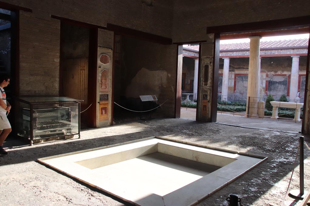 VI.15.1 Pompeii. October 2023.
Looking south-west across impluvium in atrium, towards south ala h, in centre. Photo courtesy of Klaus Heese.