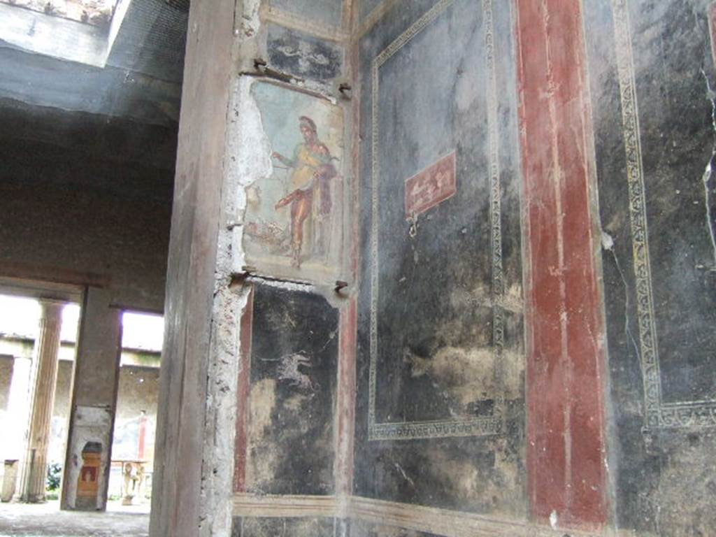 VI.15.1 Pompeii. December 2006. North-west corner of vestibule with painting of a bearded Priapus.
It seems to suggest good health is worth its weight in gold. A large basket of fruit represents the abundance of the house.