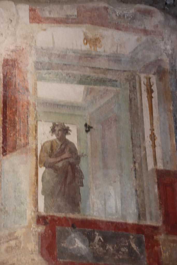 VI.15.1 Pompeii. October 2023. 
Upper east wall of exedra, painted figure with panel below, from south end of east wall. 
Photo courtesy of Klaus Heese.
