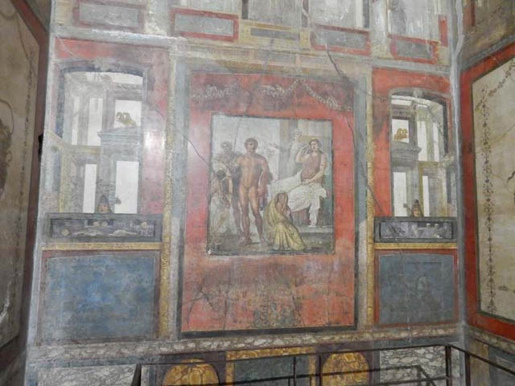 VI.15.1 Pompeii. May 2017. Looking towards the east wall, on either side of the central panel were painted panels. On the left (north side) painted food was shown, with mask above. On the right (south side) painted drinks were shown, with mask above.  Photo courtesy of Buzz Ferebee.
