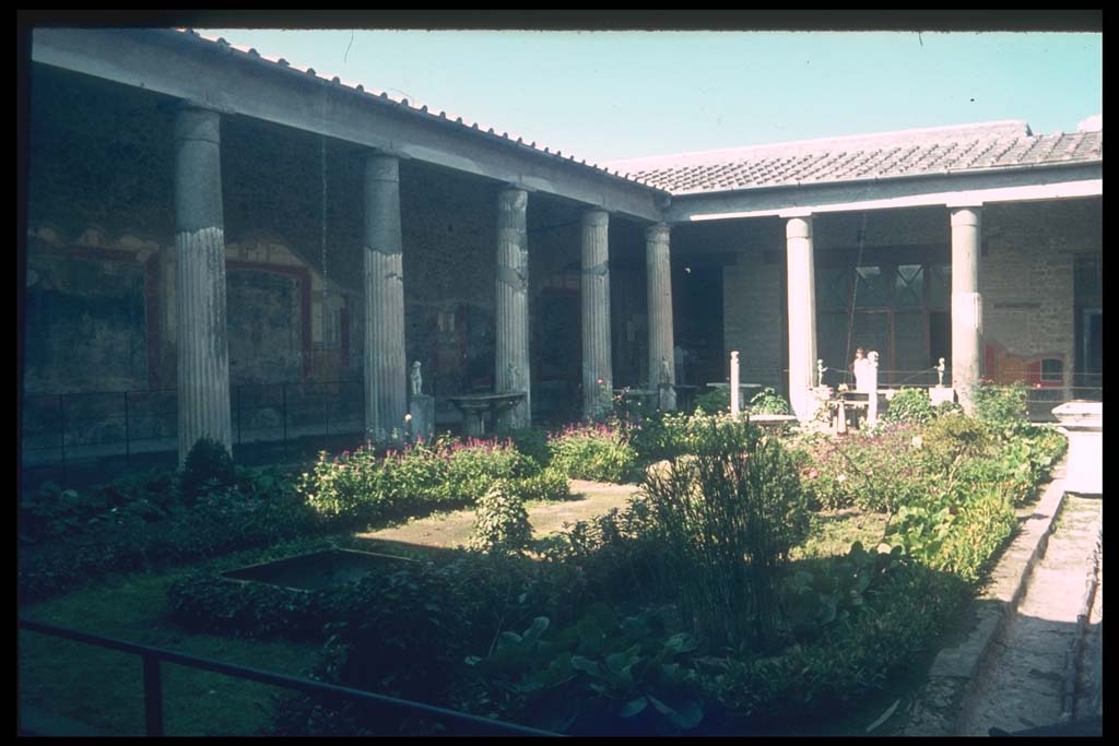 VI.15.1 Pompeii. Looking north-west across peristyle, the two double-headed herms are in place at far end.
Photographed 1970-79 by Günther Einhorn, picture courtesy of his son Ralf Einhorn.