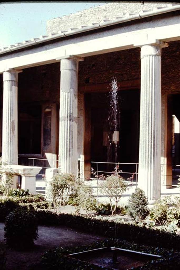 VI.15.1 Pompeii, 1968. Looking east across peristyle with fountain across portico towards doorway to atrium. Photo by Stanley A. Jashemski.
Source: The Wilhelmina and Stanley A. Jashemski archive in the University of Maryland Library, Special Collections (See collection page) and made available under the Creative Commons Attribution-Non Commercial License v.4. See Licence and use details.
J68f0095