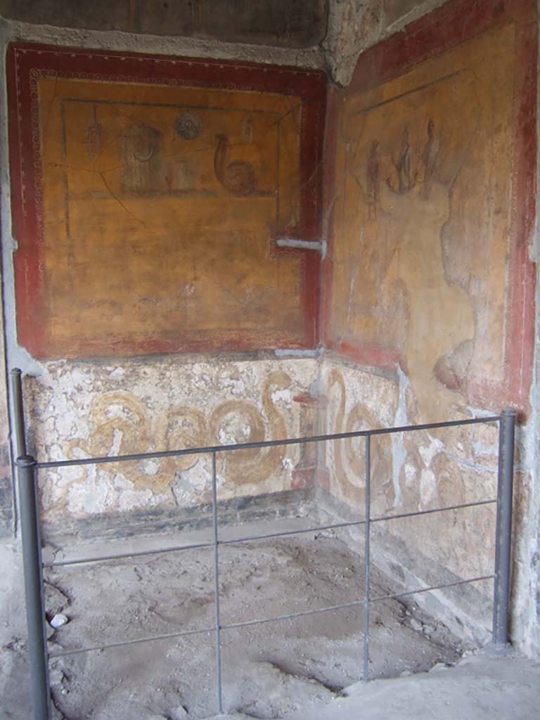 VI.16.7 Pompeii. May 2006. Room F, lararium in south-east corner of peristyle.
According to Boyce, in the south-east corner is a shrine dedicated to the cult of the Egyptian deities.
On each wall a large yellow panel is marked off by a broad red border.
See Boyce G. K., 1937. Corpus of the Lararia of Pompeii. Rome: MAAR 14. (p.56, no.220).