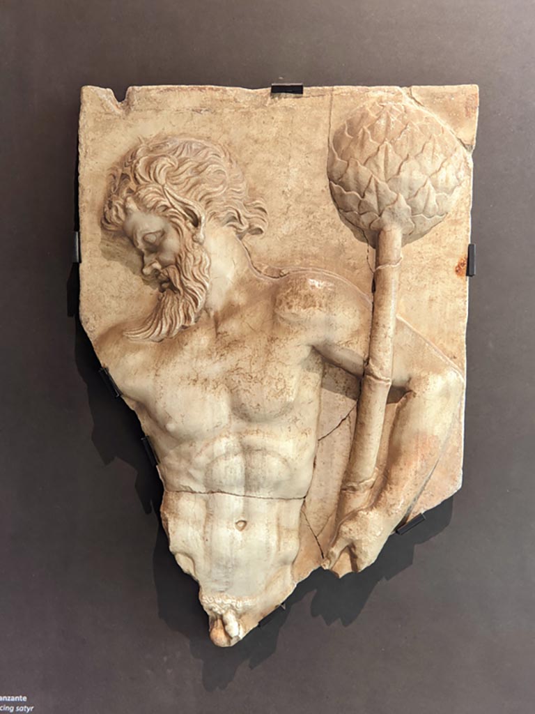 VI.16.7 Pompeii. April 2022.
Marble relief depicting a dancing satyr, on display in exhibition in Palaestra. Photo courtesy of Giuseppe Ciaramella.