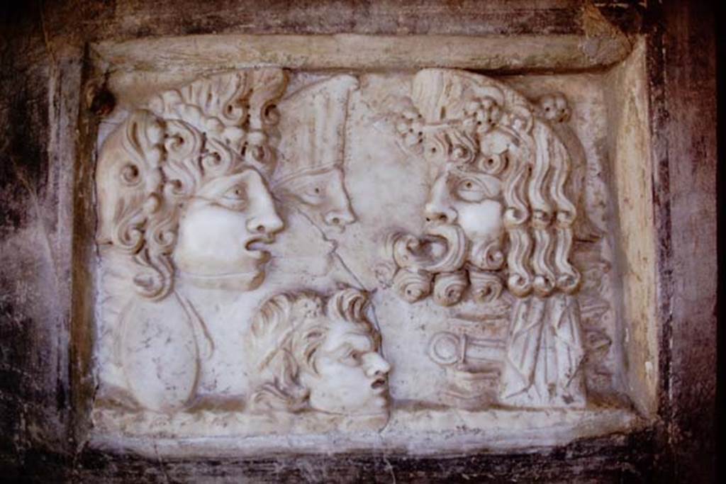 VI.16.7 Pompeii, 1968. Marble relief with masks, showing three tragic masks and a satyr, found embedded in a corner of the south wall. Photo by Stanley A. Jashemski.
Source: The Wilhelmina and Stanley A. Jashemski archive in the University of Maryland Library, Special Collections (See collection page) and made available under the Creative Commons Attribution-Non Commercial License v.4. See Licence and use details. J68f0068