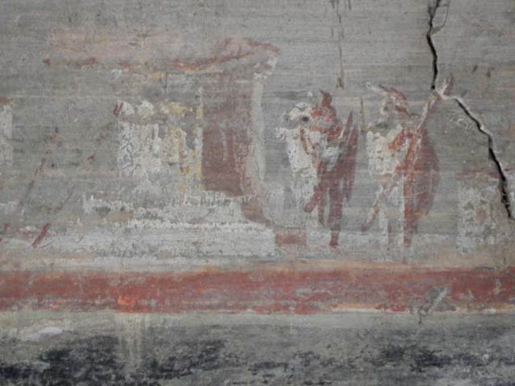 VI.16.7 Pompeii. May 2016.
Room F, detail of lower part of painting on west wall above doorway to room R. Photo courtesy of Buzz Ferebee.