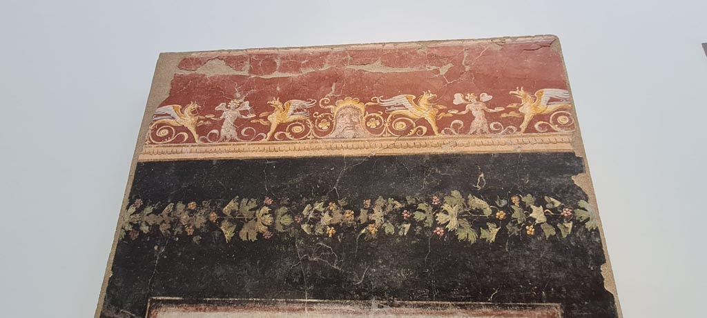 VI.17.42, Pompeii, May 2018. Triclinium 20, upper north wall above central painting. Photo courtesy of Buzz Ferebee.