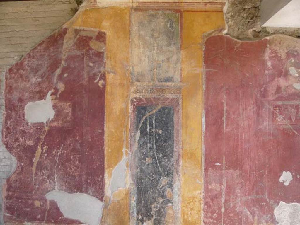 VII.1.8 Pompeii. May 2012. Detail from north wall of portico B, on east side of doorway to latrine. Photo courtesy of Buzz Ferebee.