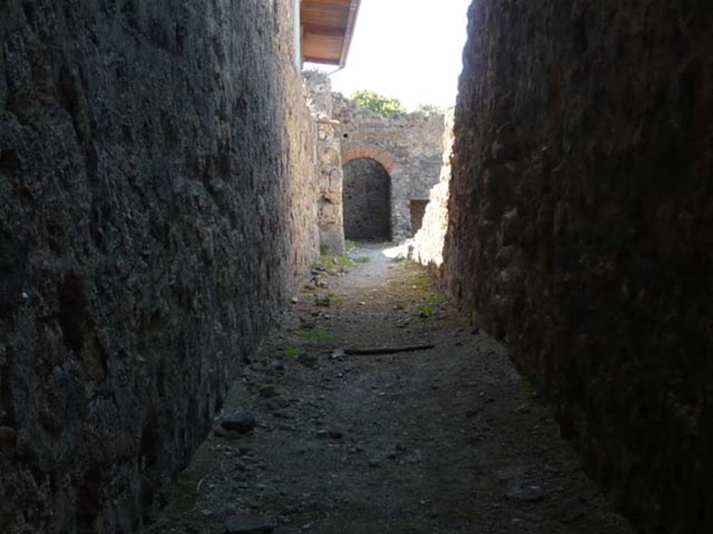 VII.1.8 Pompeii. May 2012. Corridor running south along rear of VII.1.52 to VII.1.58 on right. Photo courtesy of Buzz Ferebee.