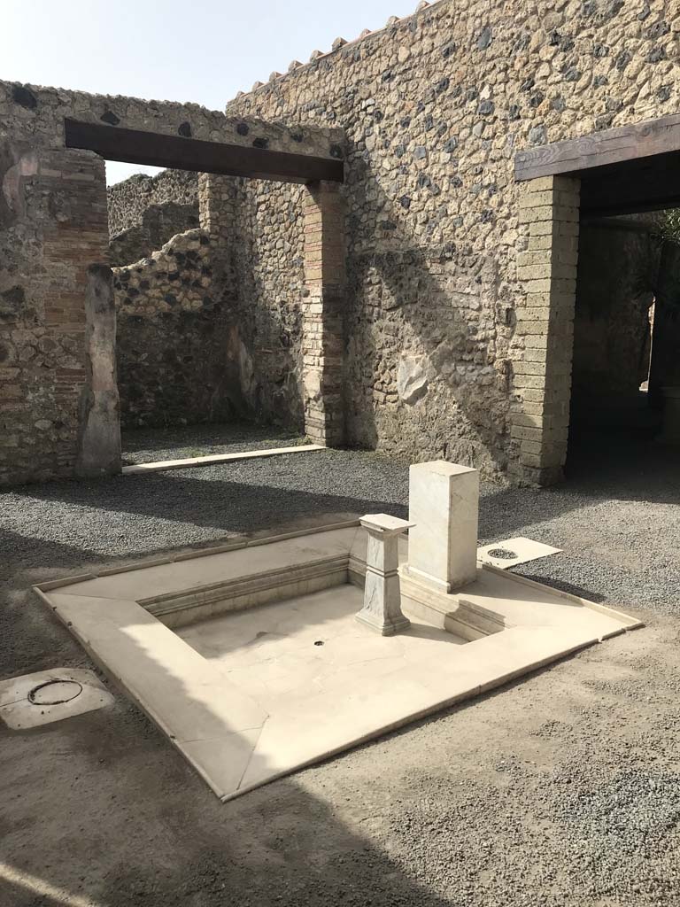 VI.1.25 Pompeii. April 2019. Looking south-west across impluvium towards doorway to Ala 30.
Photo courtesy of Rick Bauer.