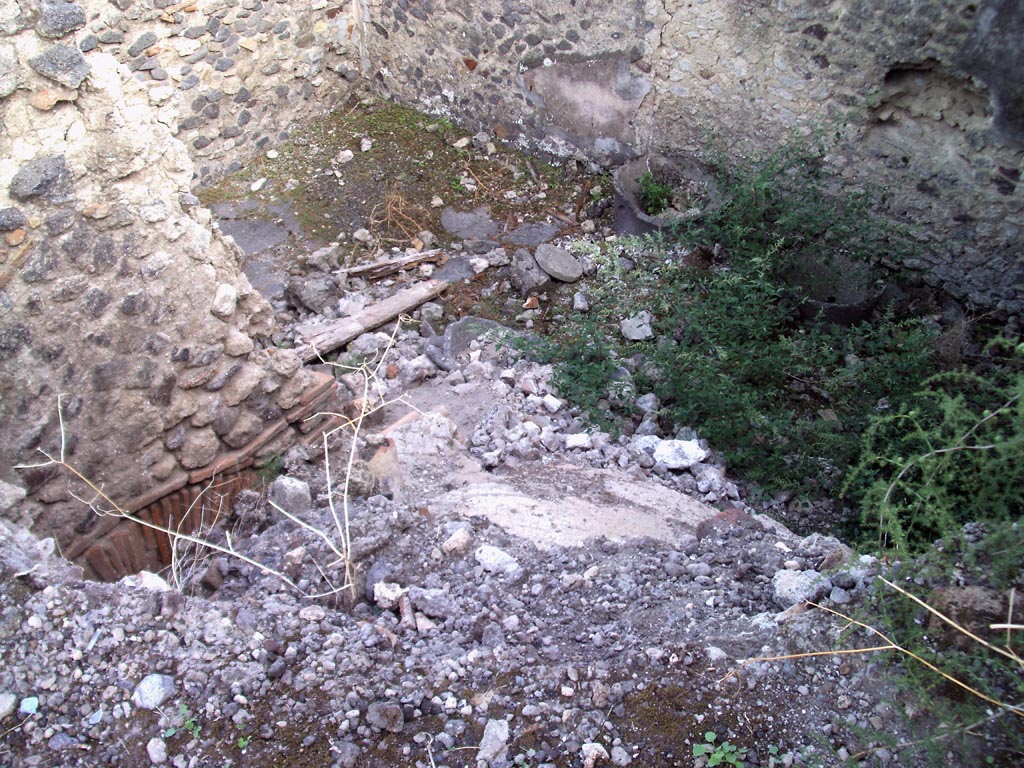VII.1.36 Pompeii. August 2008.
Looking south-east across top of rear of oven towards room in south-west corner with mills. Photo courtesy of Jared Benton.