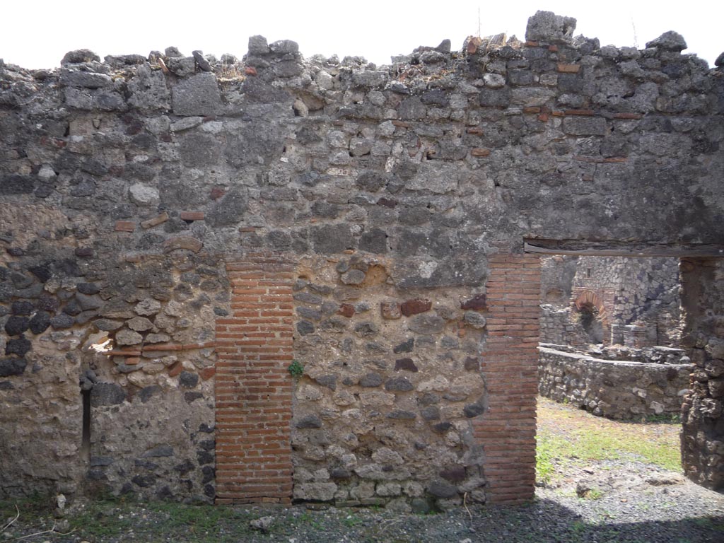 VII.1.36 Pompeii. October 2009. South wall of room on east side of entrance corridor, with doorway to atrium converted to bakery.
Photo courtesy of Jared Benton.