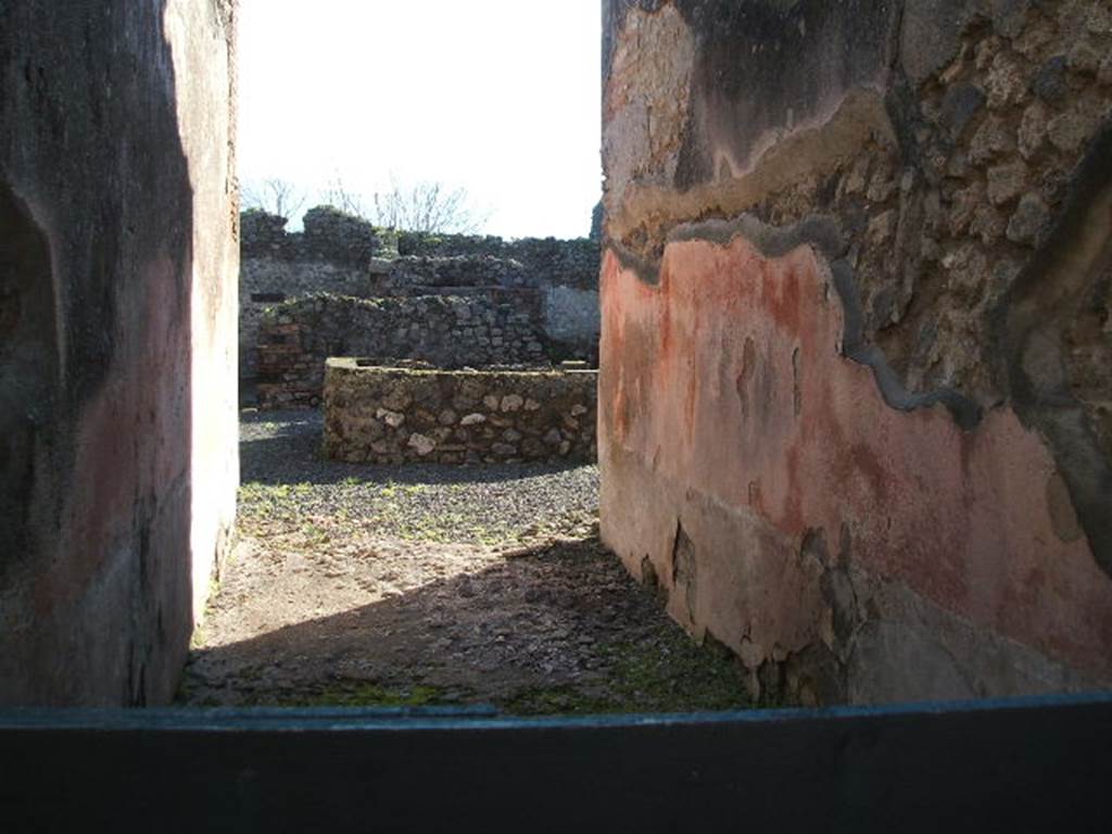 VII.1.36 Pompeii. October 2009. Looking south across large tub or basin in atrium. Photo courtesy of Jared Benton. According to Scafarti, from the entrance corridor one entered the atrium with several rooms on the sides, and where in the middle was a basin of masonry in which one could see a lead pipe and various tubes of terracotta to regulate the flow of water. Then one passed into the locality of the mills and oven, which was found shut with a bar of iron across it, and contained 81 loaves, well preserved and now to be seen in Naples Museum and Museum at Pompeii. See Scafarti, (1900): Guide to Pompei illustrated, (p.62)
According to Breton, in the centre of the atrium was found a square masonry impluvium of an exceptional shape because its sides were not less than 0.80m height above the ground: the water was brought by a visible lead pipe. On the left was a large terracotta puteal mended with lead straps. See Breton, Ernest. 1870. Pompeia, Guide de visite a Pompei, 3rd ed. Paris, Guerin. 
