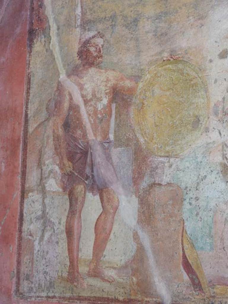 VII.1.47 Pompeii, May 2018.
Exedra 10, detail from painting on east wall showing Hephaestus with the shield and armour for Achilles..
Photo courtesy of Buzz Ferebee.