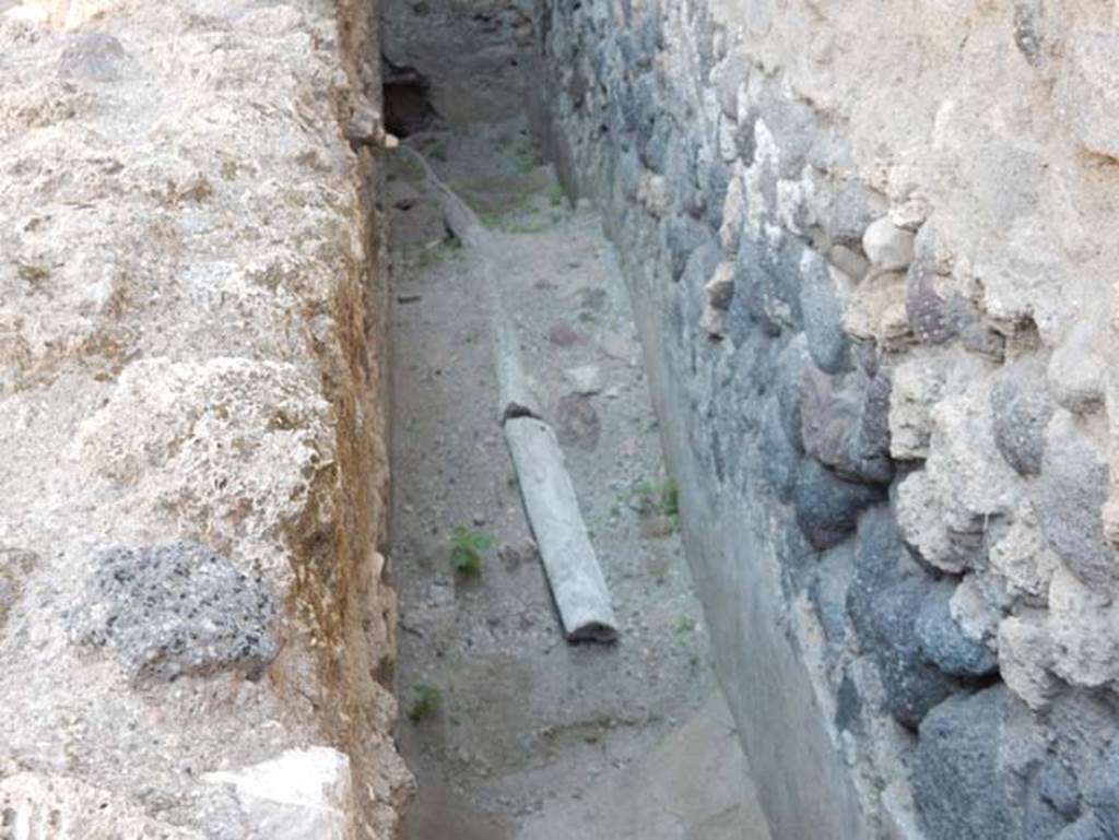 VII.1.47 Pompeii. May 2017.
Lead pipe in narrow passage at side of room 21, probably part of VII.1.17. Photo courtesy of Buzz Ferebee.
For further information on this lead pipe, see “La canalizzazione nelle “Terme Stabiane”, in Notizie degli Scavi, 1931, pages 564-575.