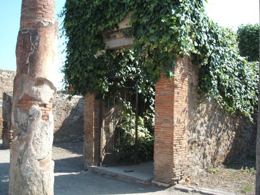 VII.4.10 Pompeii. September 2005. Entrance
According to Gell –
“Nearly opposite the entrance to the Baths, which occupies the centre of this street on the left-hand side, is a house on the right hand-side of more consequence than the rest. It has received the name of the House of Bacchus, from a large painting of the god yet existing on a wall opposite the entry.
Canals for the introduction of water are found in the Atrium, which has been surrounded by a small trough, or parterre of natural flowers, the side of which next the eye is painted blue, to represent water on which boats are floating. The wall behind this is painted with pillars, between which run balustrades of various forms, and upon these perch cranes and other birds, not badly painted, with a background of reeds or plants, and a sky visible behind. The effect must have been pretty when the whole was perfect. In the same house is the picture of a male and female sitting at the base of a pillar, attended by three cupids. In the background is a tree, with mountains in the distance. Nothing can exceed the grace of these figures in the original, and on that account, an outline of the picture has been, among others, selected for this work. See Plate XII (and see below).
In the same house is a pavement of coloured marbles, in the nature of opus Alexandrinum, which is pretty and is therefore given at the end of this work in Plate LXXXVIII.”
See Gell, W, 1832. Pompeiana: Vol 1. London: Jennings and Chaplin, (p.39-40)