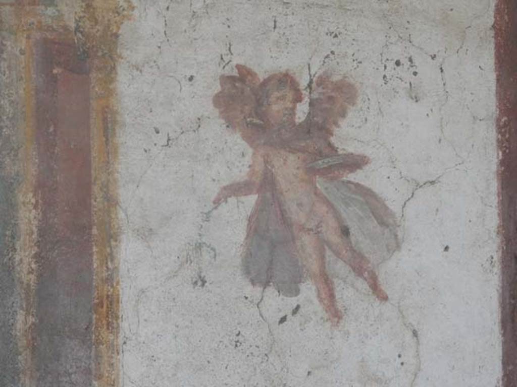 VII.4.48 Pompeii. May 2015. Room 14, flying cupid from north end of west wall of cubiculum. Photo courtesy of Buzz Ferebee.