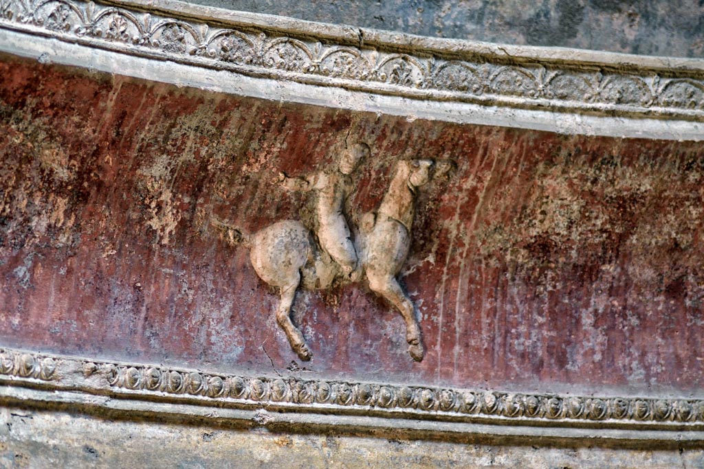 VII.5.24 Pompeii. April 2018. Frigidarium. Detail of cupid on horse-back from stucco cornice.
Photo courtesy of Ian Lycett-King. Use is subject to Creative Commons Attribution-NonCommercial License v.4 International.
