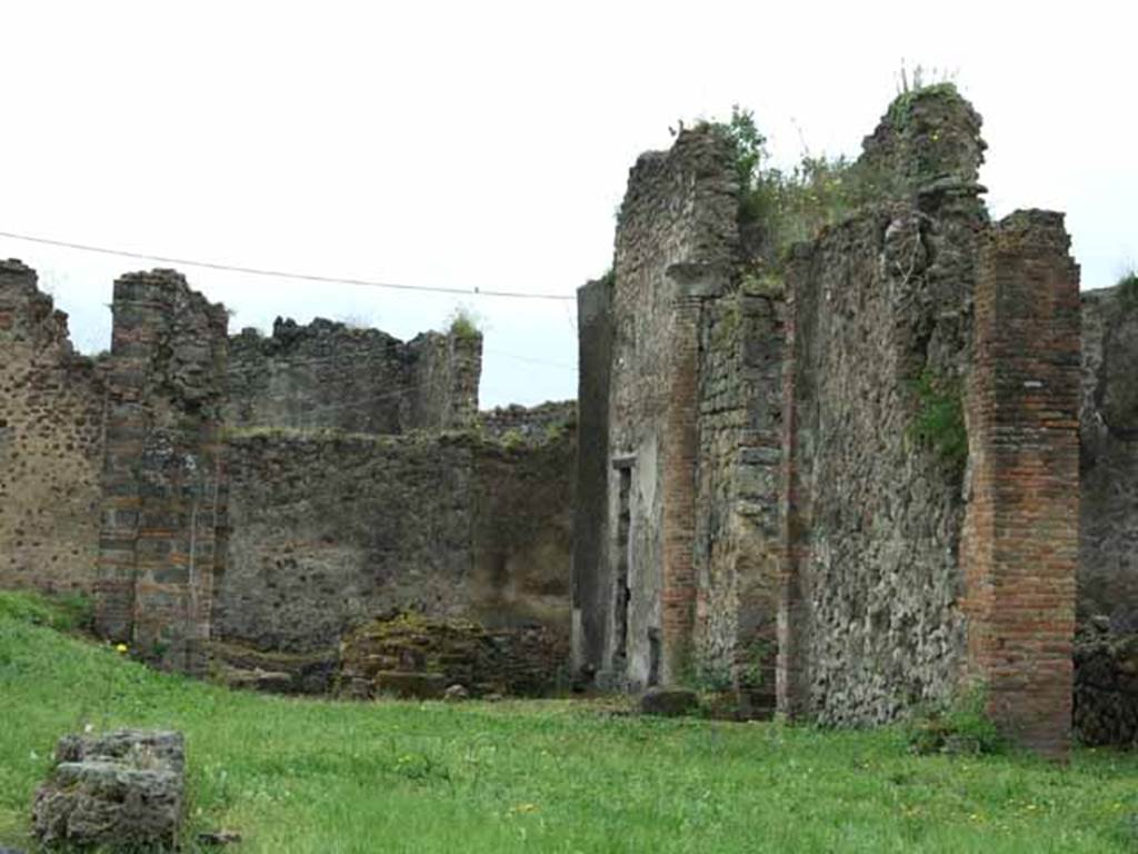 VII.6.3 Pompeii. May 2010. Looking through tablinum 12 to viridarium 18 on south side.
According to Jashemski – “The garden at the rear of the house had a portico on the north and part of the east sides.
By the time of the eruption, two of the original columns on the north side had been reinforced with pillars, the third one replaced with a pillar.
They were connected by a low masonry wall with the entrance to the garden on the north.
A water channel of Nucerian tufa outlined the garden, collecting the water from the roof which was carried by two large terracotta pipes built in the north-west and south-east corners. The water was presumably stored in a cistern.”
See Jashemski, W. F., 1993. The Gardens of Pompeii, Volume II: Appendices. New York: Caratzas. (p.184)