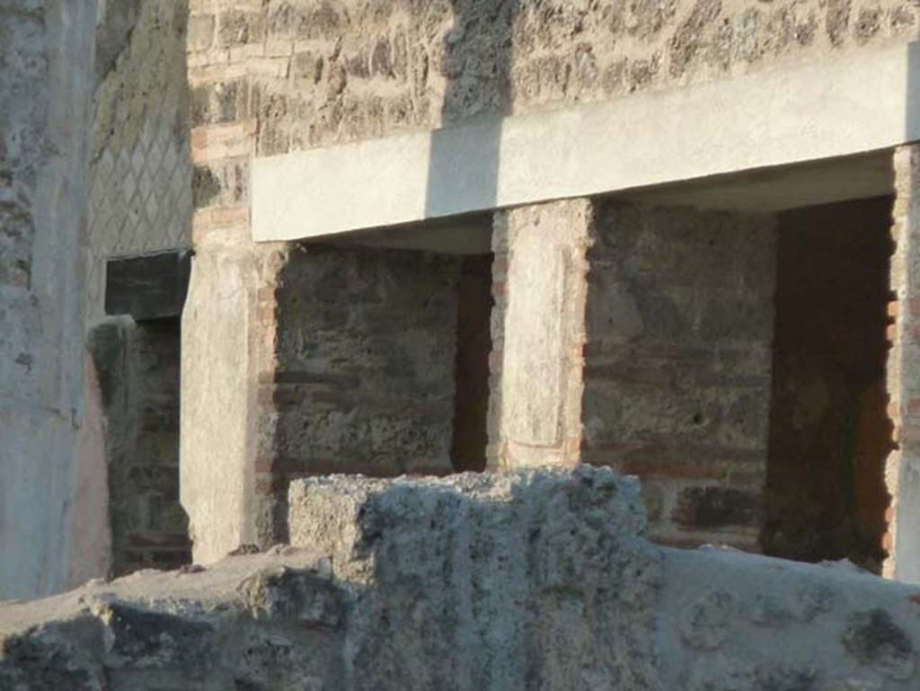 VII.7.5 Pompeii. September 2015. Doorway and window to room (n) on east side of peristyle.
Between the doorways of rooms (m) and (n) was a painting of a priestess making on offering, accompanied by an attendant.
See Sogliano, A., 1879. Le pitture murali campane scoverte negli anni 1867-79. Napoli: Giannini, no 637.