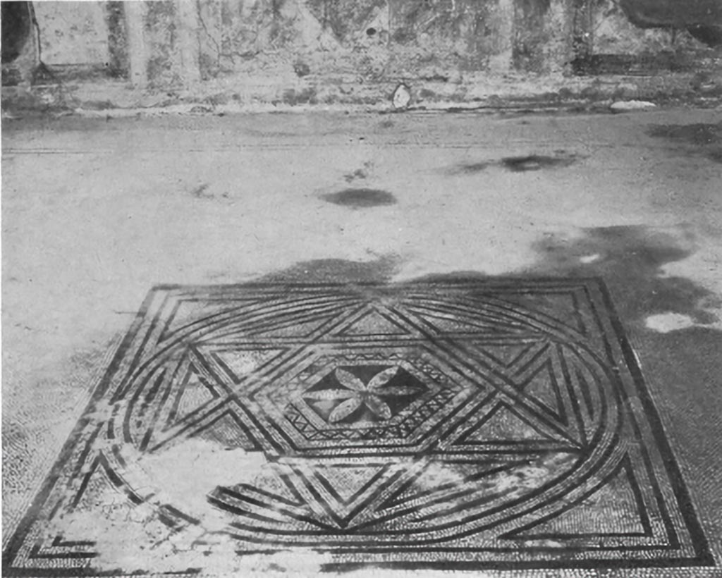 VII.7.5 Pompeii. c.1930. Flooring from the triclinium (n) on the right of the peristyle
This triclinium was constructed in the period when the symmetry of the house number 2 was destroyed by its annexation to house number 5.
On the other hand, this pavement does not belong to the last modification of the house, since it was patched at the insertion of the limestone sill upon which rests piers of the block and brick construction which was characteristic of the building activities following the earthquake of 63AD.
This centre probably belongs to the first half of the first century AD.
The tesserae of the central square are small (0.06cm) and the black ones are badly worn; the workmanship is poor.
The design of this centre is merely an adaptation of the familiar pattern showing a hexagon surrounded by triangles to make a star, which in its turn is enclosed in a larger hexagon. When the hexagon has been included in a circle and the circle in a square, the general outline of the centre is complete.
A six-petalled flower on a black background framed in an ornamental border forms the centre of the composition.
See Blake, M., (1930). The pavements of the Roman Buildings of the Republic and Early Empire. Rome, MAAR, 8, (p.114, pl.39, tav.3)
