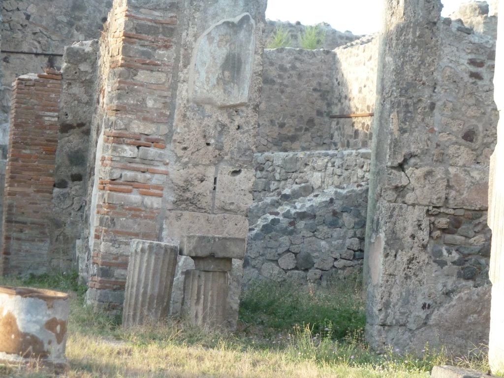 VII.7.10 Pompeii. September 2015. Looking north-east from entrance doorway across atrium.
On the left is the east side of the tablinum (k), and the doorway to oecus (n) on east side of tablinum, on right.
In oecus (n), the painting described as the birth of Rome showing the wolf with the twins Romulus and Remus would have been seen, prior to the 1943 bombing. The painting was destroyed. This painting gave the name to the house.
