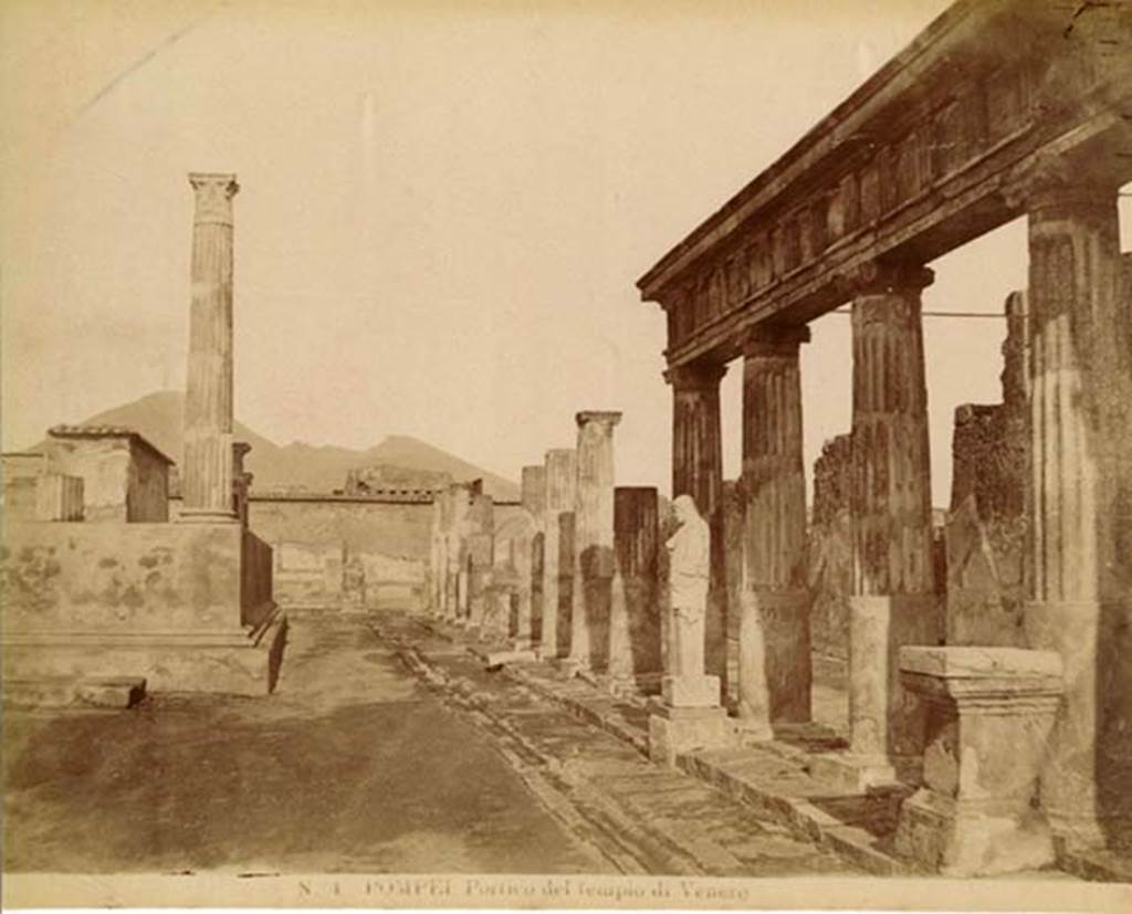 VII.7.32 Pompeii. Old undated postcard. Looking north along east side of Temple of Apollo.
Note the statue, a marble herm of Hermes or Mercury, in front of the fifth column. Photo courtesy of Rick Bauer.