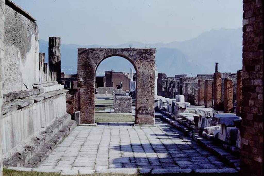 VII.8 Pompeii Forum, 1968. Looking south through large arched doorway in north wall of Forum. Photo by Stanley A. Jashemski.
Source: The Wilhelmina and Stanley A. Jashemski archive in the University of Maryland Library, Special Collections (See collection page) and made available under the Creative Commons Attribution-Non Commercial License v.4. See Licence and use details.
J68f2329