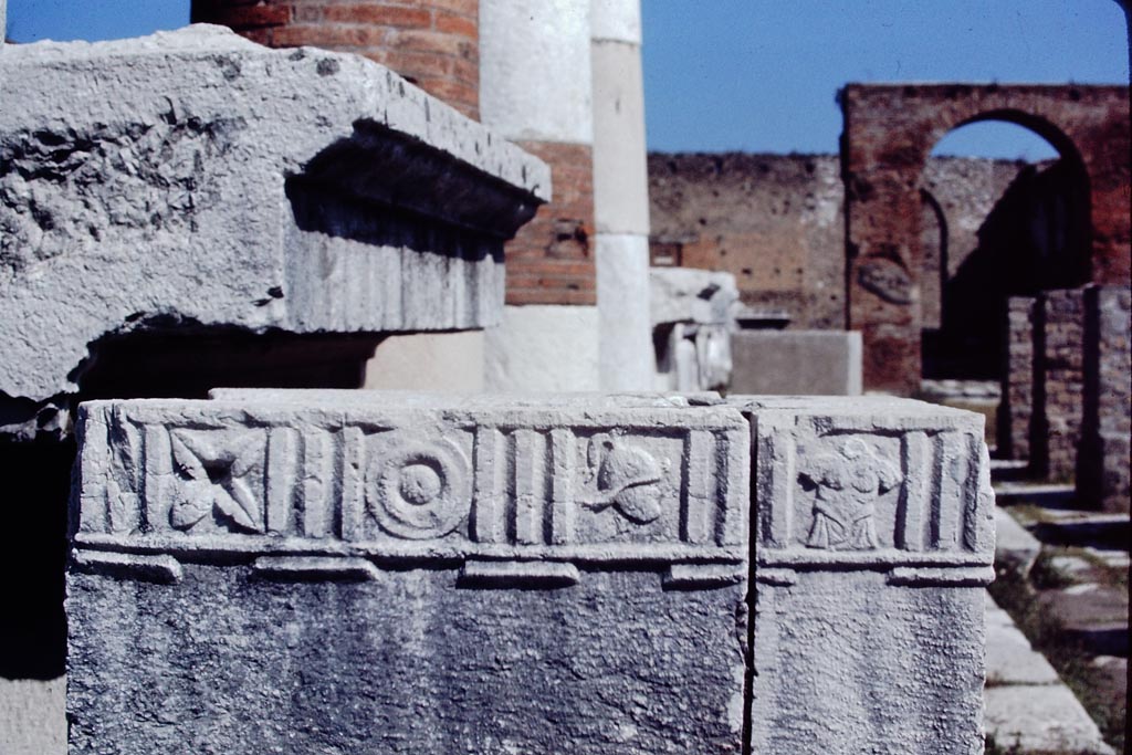 VII.8 Pompeii Forum. 1968.
Looking north at south side. Statue base decorated with flower, shield, helmet and armour motifs. Photo by Stanley A. Jashemski.
Source: The Wilhelmina and Stanley A. Jashemski archive in the University of Maryland Library, Special Collections (See collection page) and made available under the Creative Commons Attribution-Non-Commercial License v.4. See Licence and use details.
J68f0989