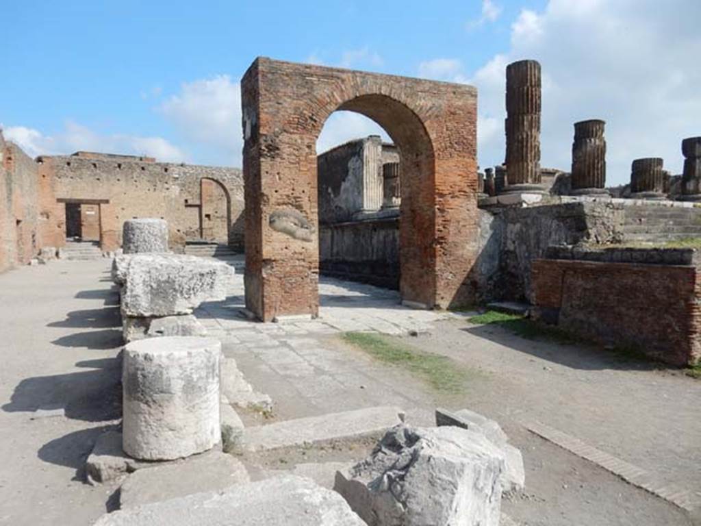 VII.8.1 Pompeii. May 2015. Looking towards Arch of Augustus and Temple of Jupiter, in north-west corner of Forum.
Photo courtesy of Buzz Ferebee.
For a description of excavations carried out on the north side of the Temple, and in the north-west corner of the Forum (west side of Temple),
See Notizie degli Scavi, 1942, (p.309-320).