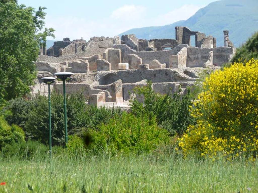 VII.16 Pompeii. May 2011. Looking south-east across rear of VII.16.16, and VII.16.15.
Photo courtesy of Michael Binns.