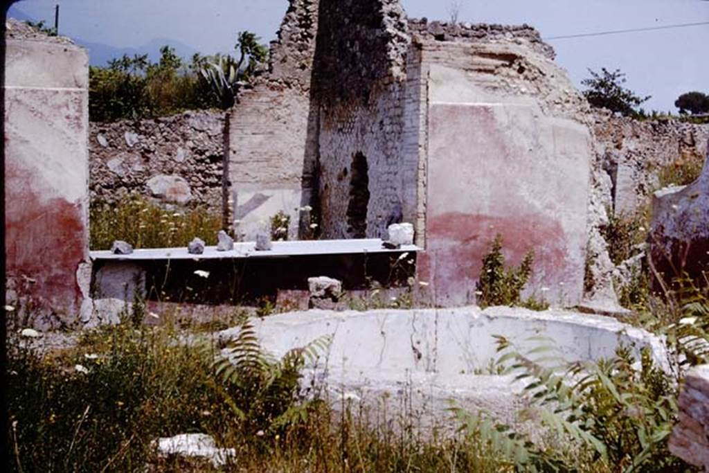 VII.16.22 Pompeii. 1964. Looking north-east across circular pool which would have had a fountain jet and would have been painted blue, through the window of the large room,.
At the rear of the large room, the north wall of the atrium can be seen. Photo by Stanley A. Jashemski.
Source: The Wilhelmina and Stanley A. Jashemski archive in the University of Maryland Library, Special Collections (See collection page) and made available under the Creative Commons Attribution-Non Commercial License v.4. See Licence and use details.
J64f2025
