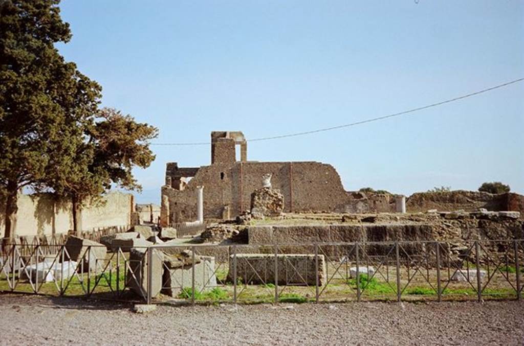 VIII.1.3 Pompeii. January 2010. Looking east to entrance from north-west corner. Photo courtesy of Rick Bauer. According to Carroll, “Looking east towards view of the temple as it was being enlarged after 62AD. The upright core is part of the mid-first century BC temple.
The still intact courses of large basalt blocks were laid into a construction trench surrounding the earliest building. The scattered basalt blocks in the courtyard are remnants of building work”. See: Carroll, M. (2010): Exploring the sanctuary of Venus and its sacred grove: politics, cult and identity in Roman Pompeii. In: Papers of the British School at Rome 78, (2010) pp.63-106.