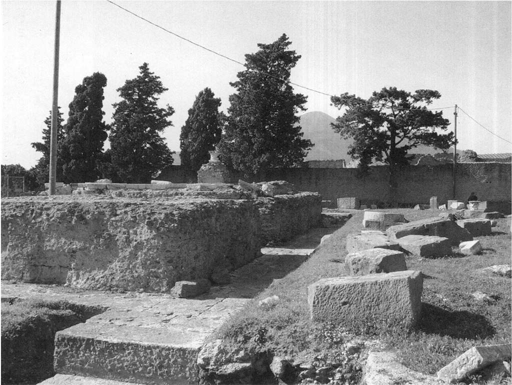 VIII.1.3 Pompeii. View from the south of the temple as it was being enlarged after AD 62. The upright opus caementicium core is part of the mid-first-century BC temple; the still intact courses of large basalt blocks were laid into a construction trench surrounding the earliest building. The scattered basalt blocks in the courtyard are remnants of this building work. Photo courtesy of M. Carroll.
See Carroll M., 2010. Exploring the sanctuary of Venus and its sacred grove: politics, cult and identity in Roman Pompeii. Papers of the British School at Rome 78, p.89 plate 21.