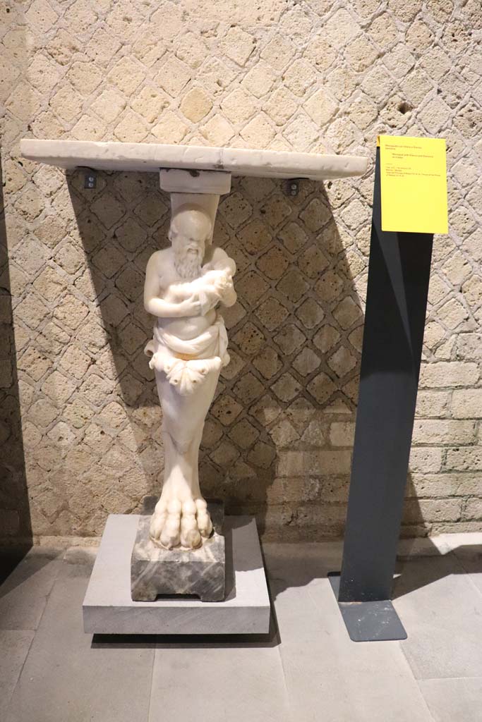 VIII.1.4 Pompeii Antiquarium. February 2021. 
Marble monopodium, with Silenus and Dionysus as a baby, found in VI.15.8.
Photo courtesy of Fabien Bi�vre-Perrin (CC BY-NC-SA).

