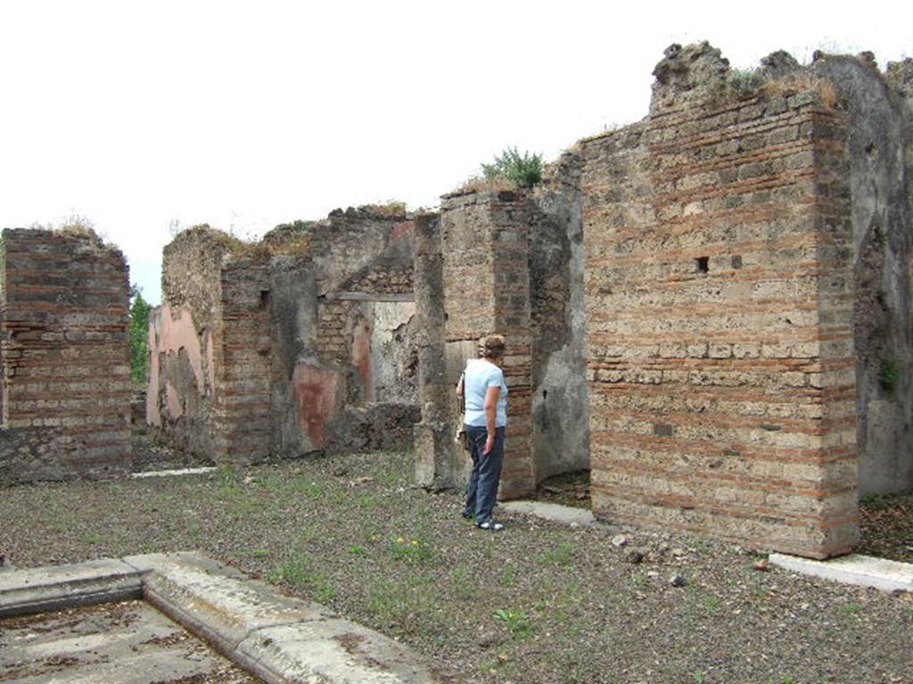 VIII.2.39 Pompeii. May 2006. West side of atrium, looking south.
Doorways to room q, andron/corridor, room h, ala, and rooms k and l, on west side of atrium.