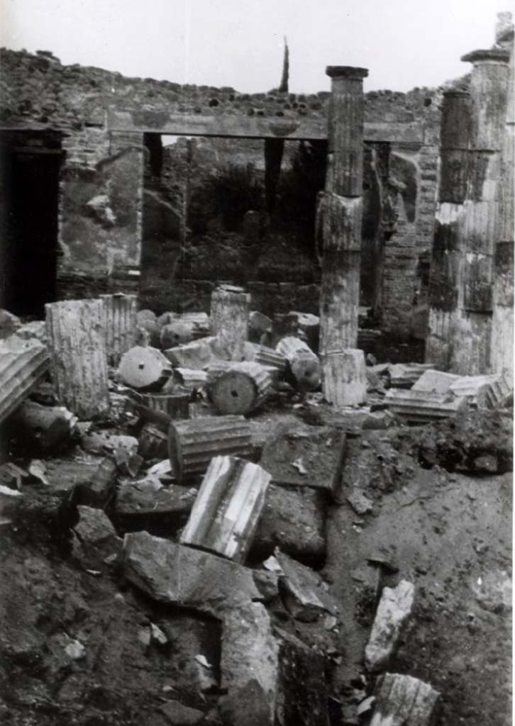IX.1.20 Pompeii. c.1943-6. Room 2, atrium. Bomb damage.
According to Garcia y Garcia, this house was one of the most savagely damaged during one of the allied air raids in September 1943.
The great Corinthian atrium, hit in its centre in the middle of the impluvium, was completely annihilated, with the destruction of the impluvium and the cutting down of the sixteen tufa Doric columns.
The bombing also caused the demolition of the façade wall towards the Via dell’Abbondanza, including the fauces and the neighbouring rooms.
With the immediate restoration and by saving every little snippet, the columns were reconstructed, but it was only possible to restore a fraction of the facade.
See Garcia y Garcia, L., 2006. Danni di guerra a Pompei. Rome: L’Erma di Bretschneider. (p.149-50)
Photo courtesy of British School at Rome Digital Collections.
See Photo details at BSR